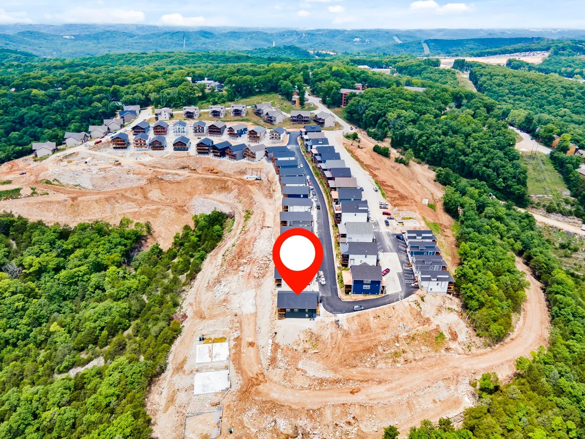 A vibrant exterior shot featuring newly constructed homes nestled amid lush greenery, with a well-laid road inviting exploration. The scene exudes an optimistic mood, suggesting the excitement of being in a community that's just steps away from adventure.